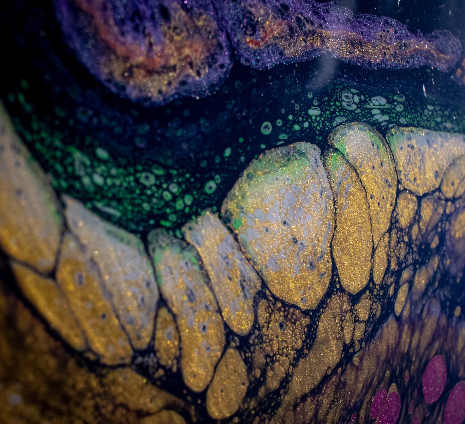 A close-up view of the blacklight fluorescent acrylic pour painting "A Galaxy of Metal"